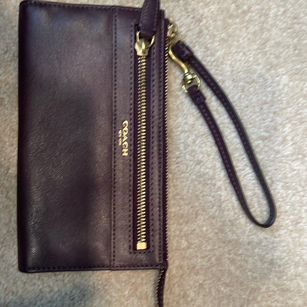 Coach eggplant color wristlet.